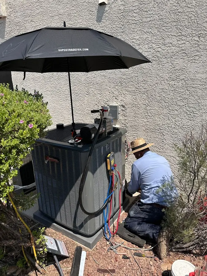HVAC technician performing outdoor AC maintenance in Clarcona